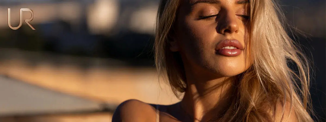 A woman with long blonde hair, softly lit, looking serene.