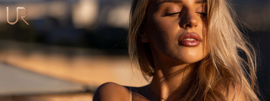 Young woman with long blonde hair, softly illuminated in natural light.